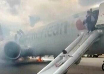 Passengers flee on emergency slide after American Airlines Boeing in Denver suffers landing gear fire