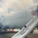 Passengers flee on emergency slide after American Airlines Boeing in Denver suffers landing gear fire