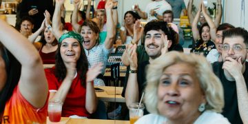 Iran diaspora watches World Cup game with protests, support