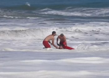 Dramatic video shows a 10-year-old boy rescued from pounding waves