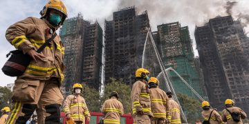 Hong Kong leader apologizes for deadly fire that tested Beijing’s grip on city