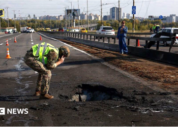 Kyiv bridge hit in further Russian drone attack as German chancellor makes surprise visit