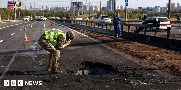 Kyiv bridge hit in further Russian drone attack as German chancellor makes surprise visit